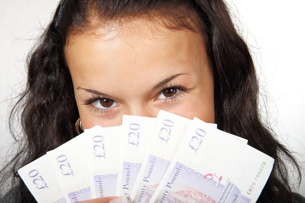 Woman Holding Money To Face