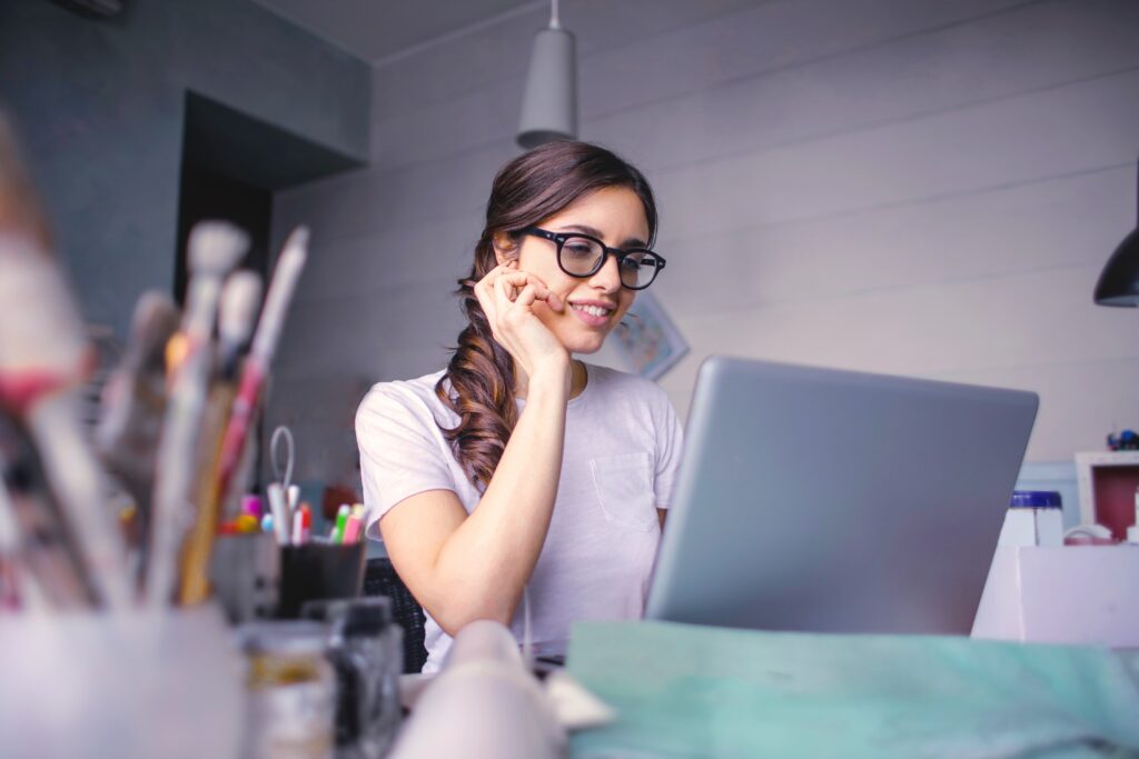 Woman Smiling Using Computer